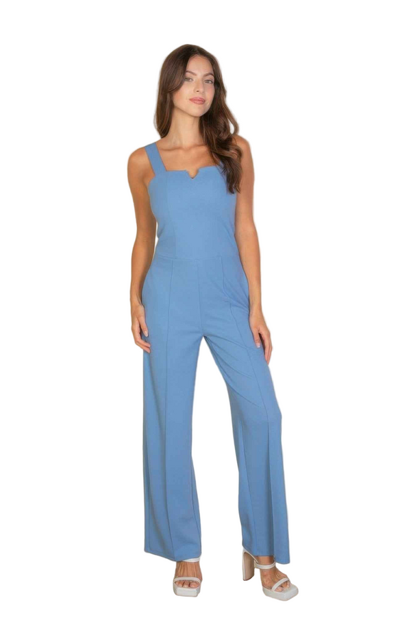 Woman wearing a blue jumpsuit on a white background