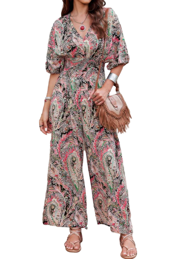 Woman wearing a floral patterned jumpsuit on a white background
