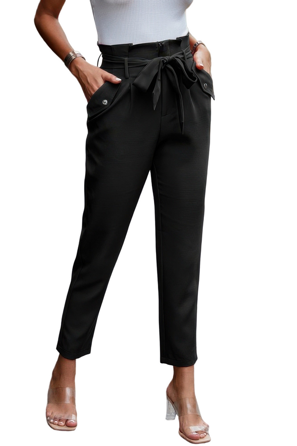 Black pants with a tie waist worn by a person on a white background